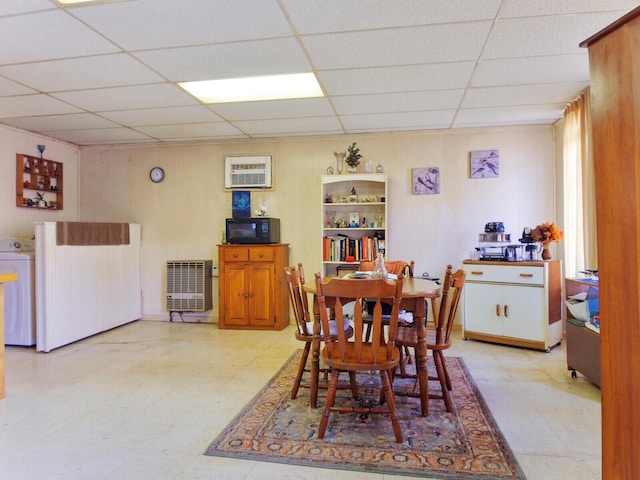 dining space featuring a drop ceiling, washer / clothes dryer, and heating unit