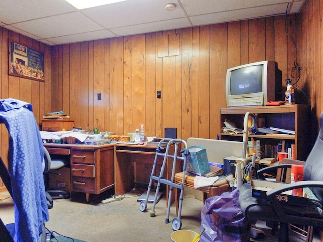 office featuring carpet flooring, a drop ceiling, and wooden walls