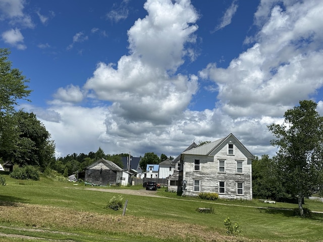 19 River Rd, Oakfield, ME 04763 - exterior space featuring stone siding, metal roof, and a lawn