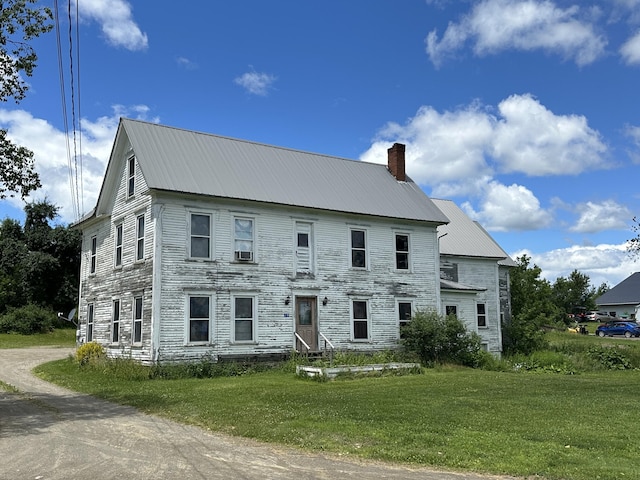 19 River Rd, Oakfield, ME 04763 - colonial home featuring metal roof, a front lawn, and a chimney