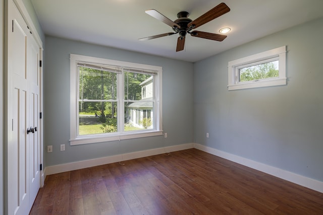 empty room with ceiling fan and dark wood-type flooring