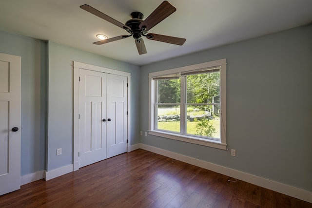 unfurnished bedroom featuring ceiling fan, a closet, and dark hardwood / wood-style floors