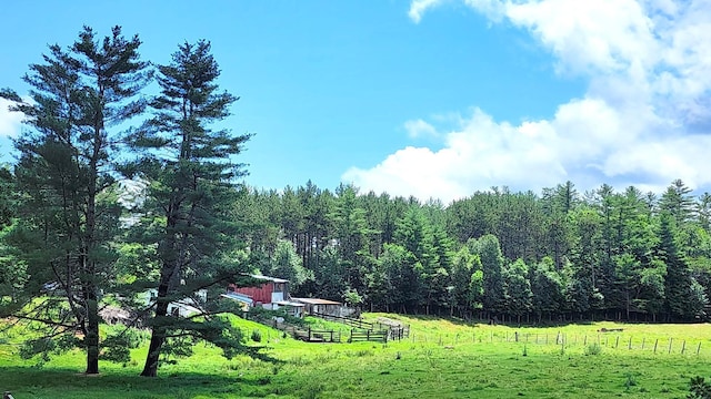 exterior space featuring a rural view and a lawn