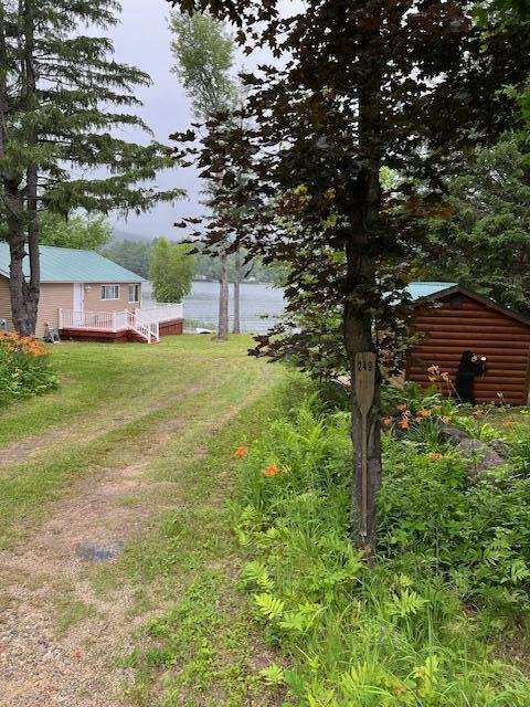 view of yard with a deck with water view