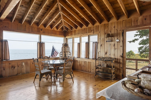 sunroom featuring a water view, wood ceiling, and lofted ceiling with beams