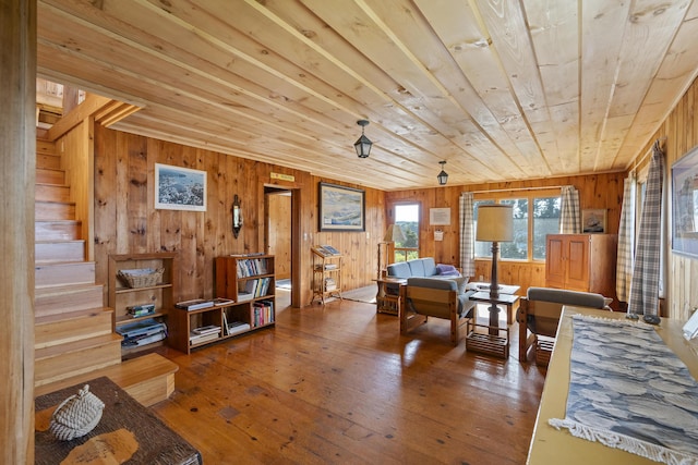 dining room featuring wood-type flooring, wooden walls, and wood ceiling