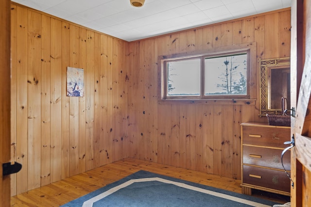 interior space featuring wood-type flooring and wooden walls