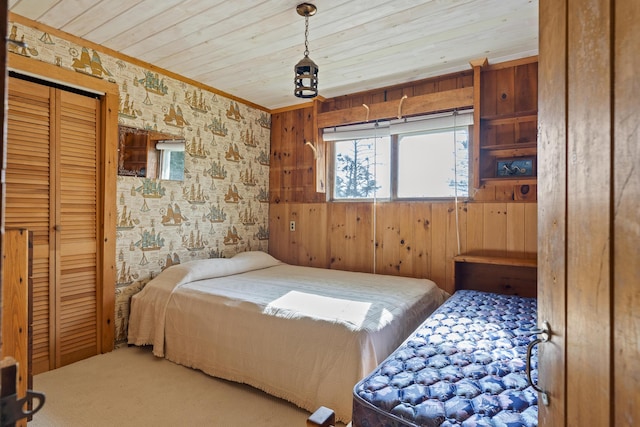 bedroom with wood ceiling, carpet floors, and ornamental molding