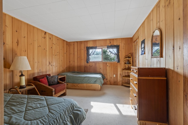 carpeted bedroom with wood walls