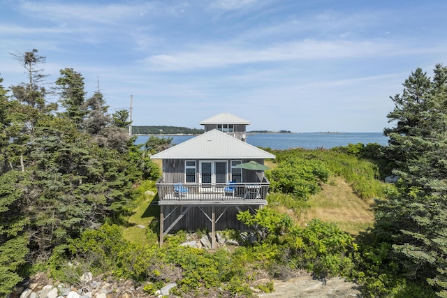 rear view of house with a deck with water view