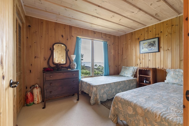 bedroom featuring wooden ceiling, carpet, and wood walls