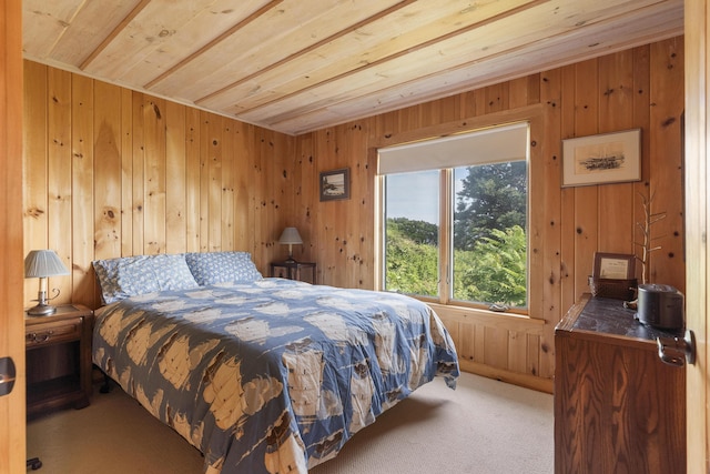 bedroom with wooden ceiling, wood walls, and carpet flooring