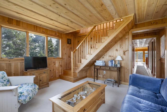 living room with light carpet, wood ceiling, and wood walls