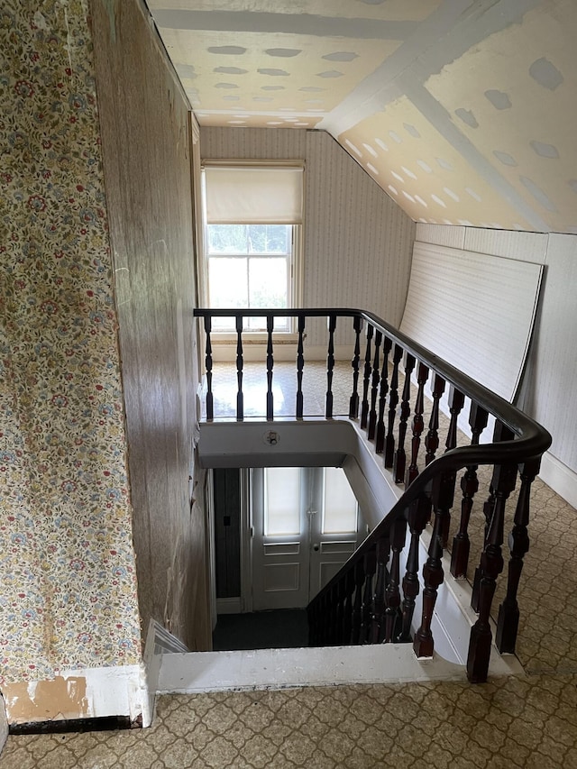 staircase with lofted ceiling