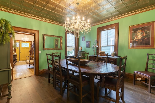 dining space featuring hardwood / wood-style floors and a notable chandelier