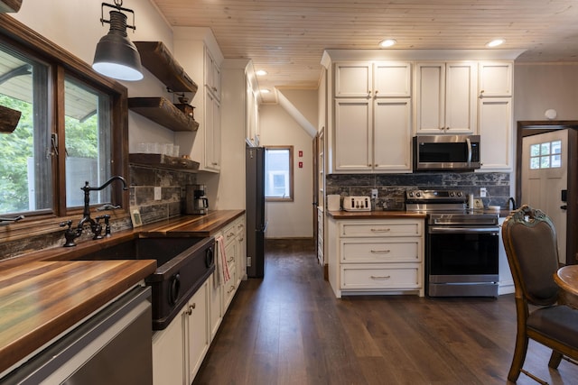 kitchen featuring white cabinets, wood ceiling, wooden counters, dark hardwood / wood-style flooring, and stainless steel appliances