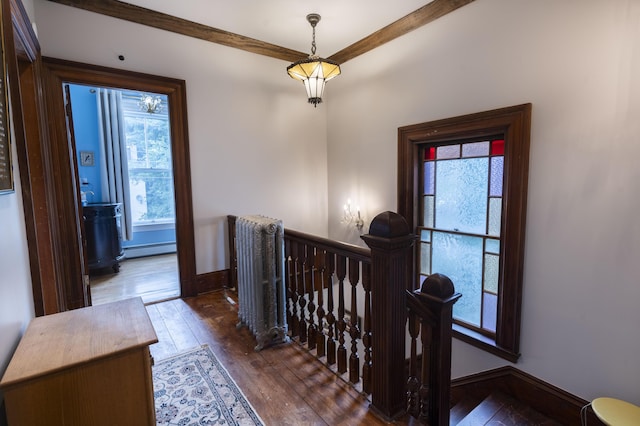 hallway featuring dark wood-type flooring and baseboard heating