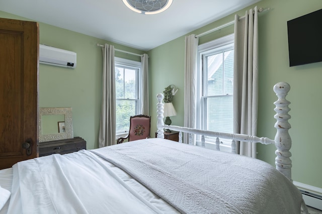 bedroom with baseboard heating and a wall mounted AC