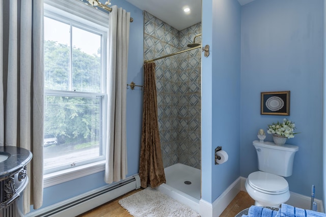 bathroom featuring toilet, a shower with curtain, hardwood / wood-style floors, and a baseboard radiator