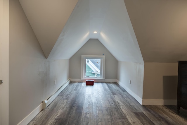 bonus room with lofted ceiling, dark hardwood / wood-style floors, and a baseboard radiator