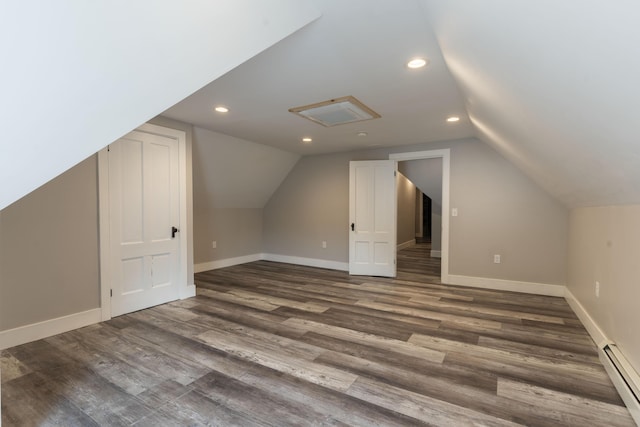 additional living space with baseboard heating, dark hardwood / wood-style floors, and vaulted ceiling