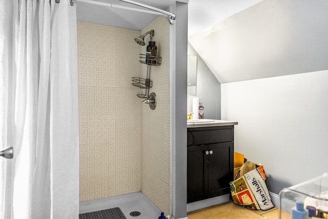 bathroom with vanity, vaulted ceiling, and a shower with shower curtain