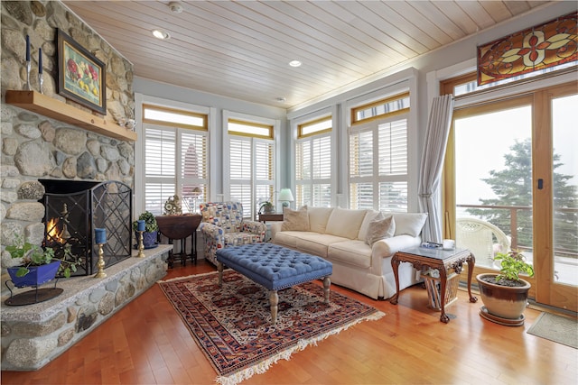 living room featuring wood ceiling, a fireplace, and hardwood / wood-style floors