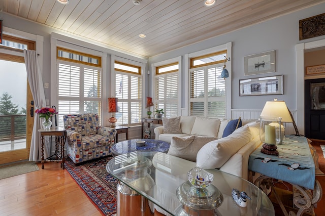 living room featuring wood-type flooring, a wealth of natural light, and wood ceiling