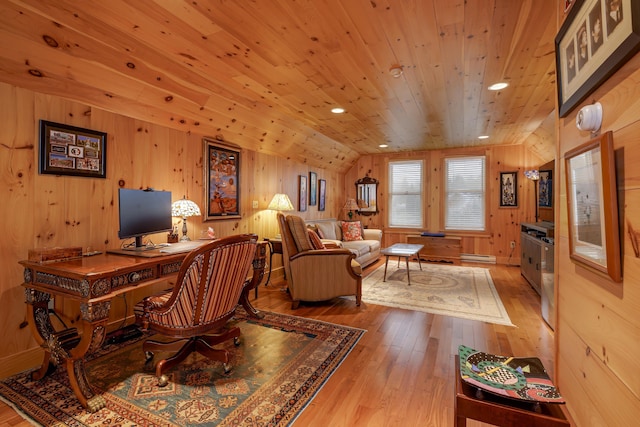 office space featuring lofted ceiling, wood walls, wooden ceiling, light wood-type flooring, and a baseboard radiator