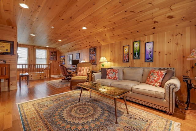 living room featuring light hardwood / wood-style floors, lofted ceiling, wood ceiling, and wooden walls