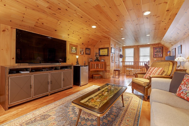 living room with lofted ceiling, light hardwood / wood-style flooring, wood walls, and wooden ceiling