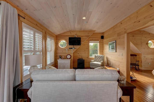 living room featuring lofted ceiling, wood ceiling, wooden walls, and hardwood / wood-style floors