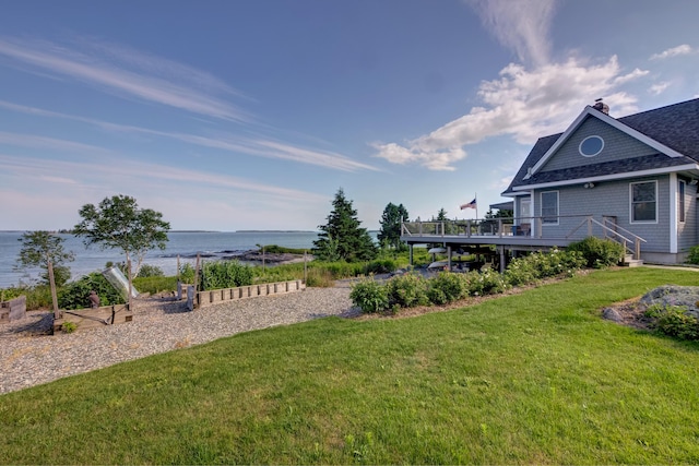 view of yard with a deck with water view