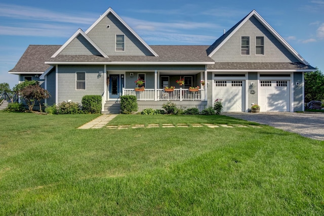 view of front of home with a garage, a porch, and a front yard