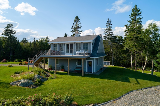 back of house featuring a deck and a yard