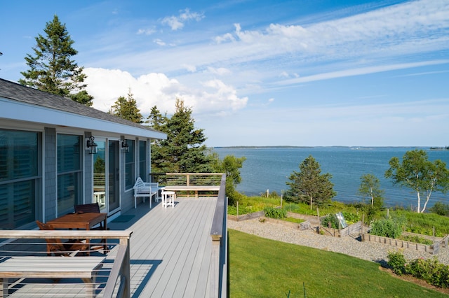 deck with a water view and a yard