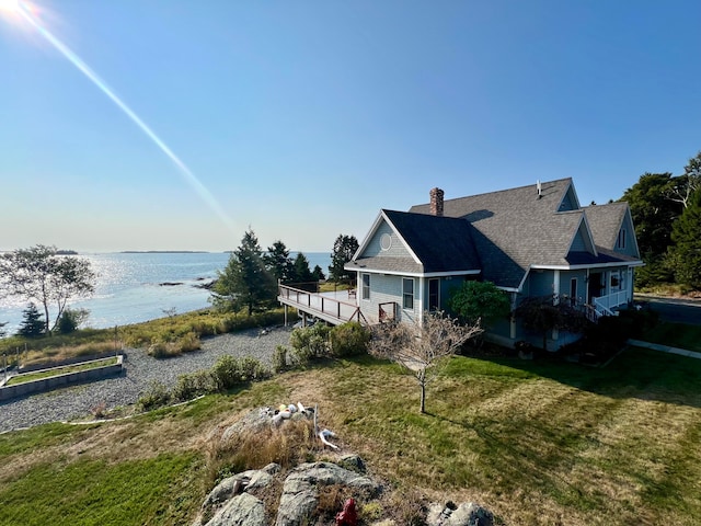 exterior space with a water view and a yard