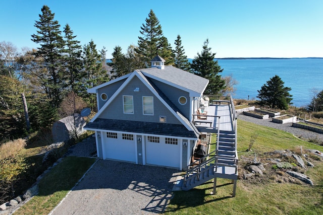 exterior space with a water view and a garage