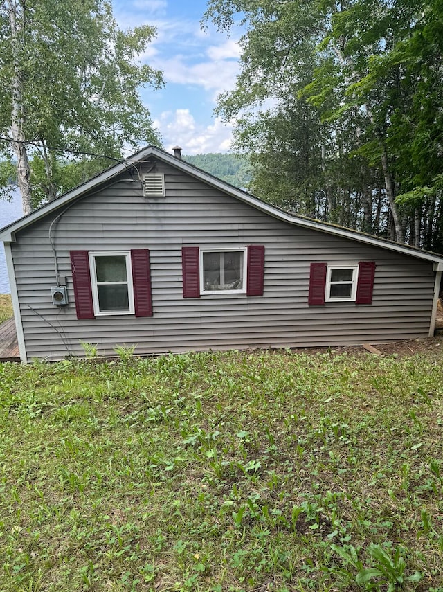 view of side of property with a yard