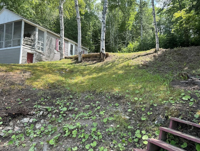 view of yard with a sunroom