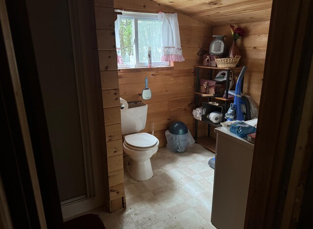 bathroom featuring lofted ceiling, wood ceiling, toilet, and wooden walls