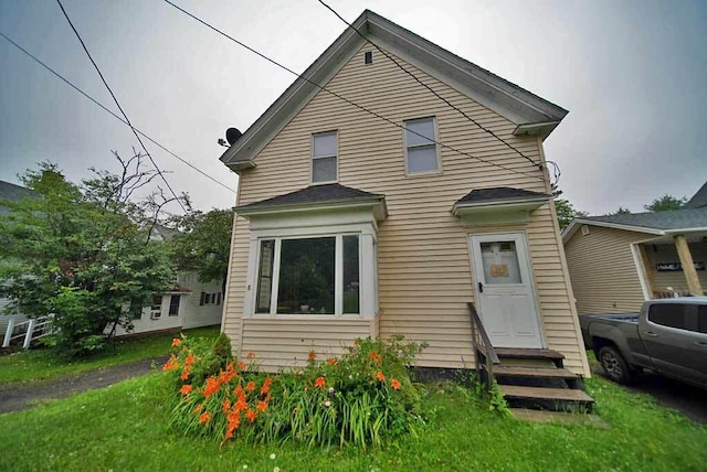 rear view of house with a yard