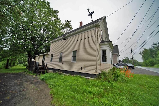 view of side of home featuring a lawn