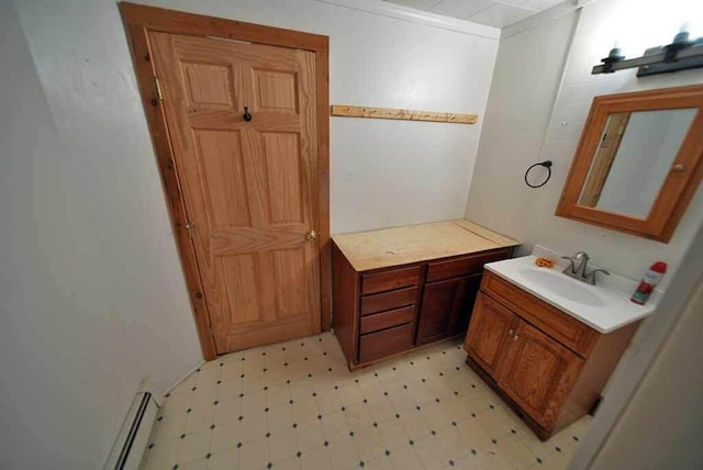 bathroom with crown molding and vanity