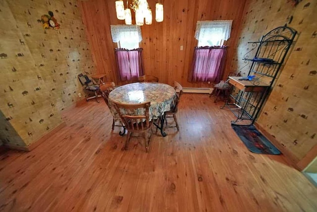 unfurnished dining area with plenty of natural light, a chandelier, and wood-type flooring