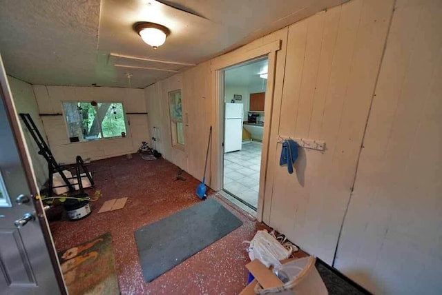 hallway with wood walls