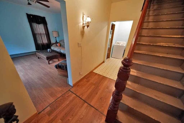 hallway featuring washer / clothes dryer and hardwood / wood-style flooring