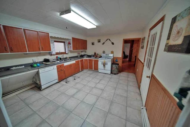 kitchen with sink, white appliances, and a baseboard radiator