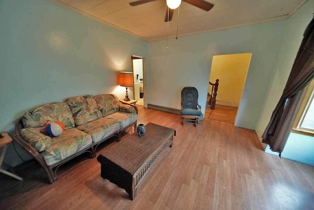 living room featuring ceiling fan, a baseboard radiator, and hardwood / wood-style floors