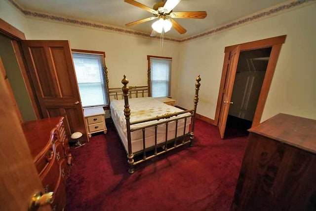 bedroom featuring ceiling fan and dark colored carpet